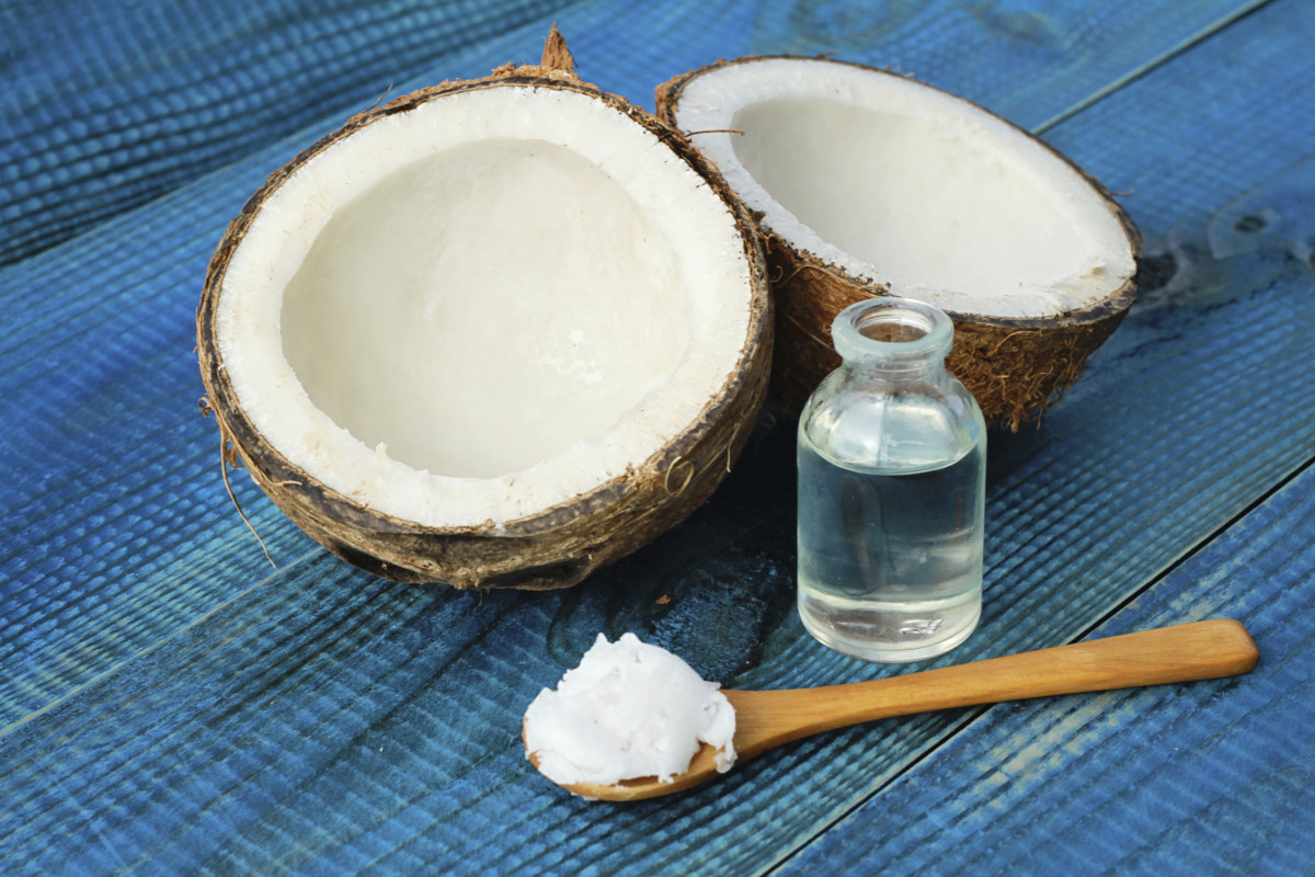 Coconut and coconut oil on blue rustic wooden background
