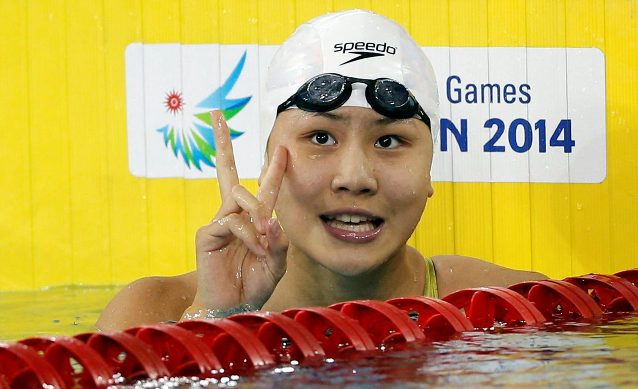FILE PHOTO - China's Chen Xinyi celebrates after winning the women's 50m freestyle final swimming competition at the Munhak Park Tae-hwan Aquatics Center during the 17th Asian Games in Incheon September 26, 2014. REUTERS/Tim Wimborne/File Photo