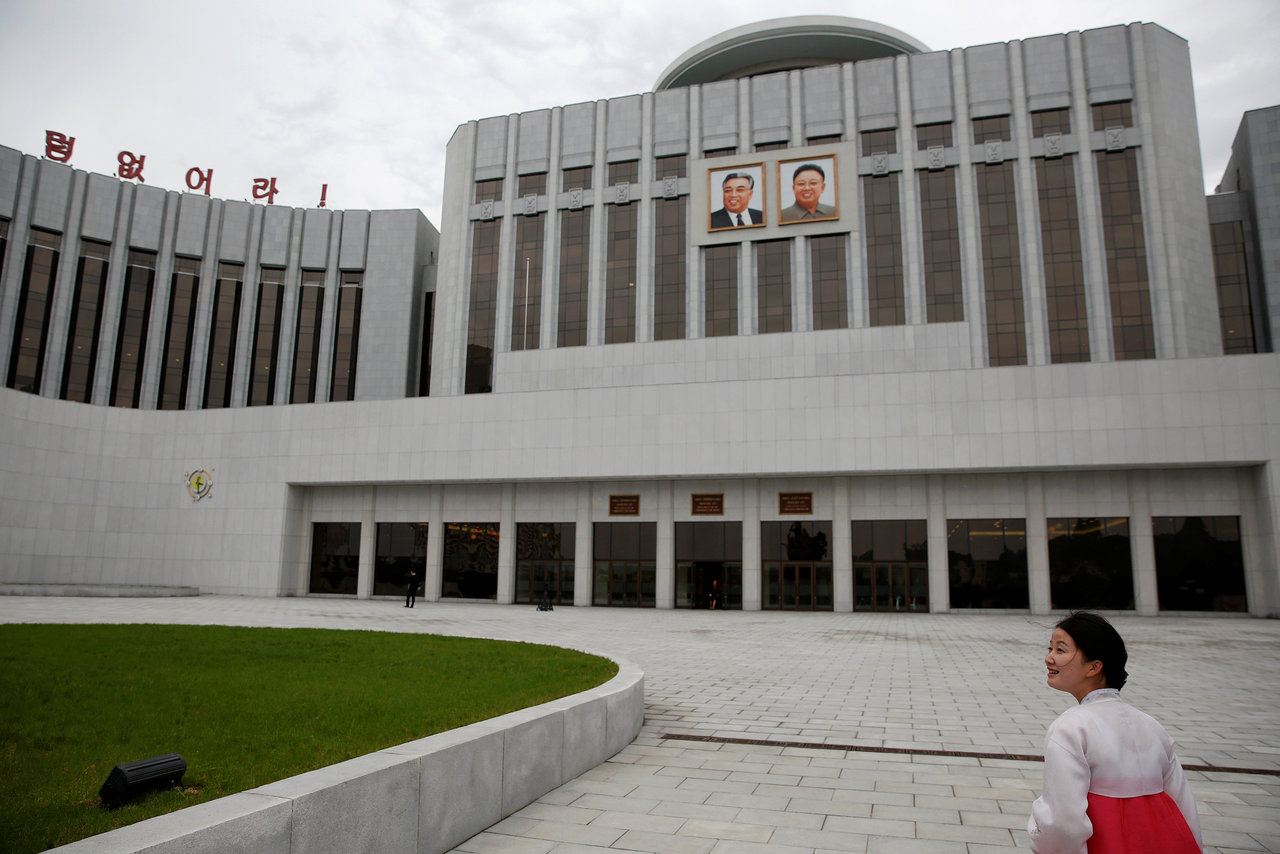 A guide leads visitors towards the Mangyongdae Children's Palace decorated with pictures of former North Korean leaders Kim Il Sung and Kim Jong Il in central Pyongyang, North Korea May 5, 2016. REUTERS/Damir Sagolj