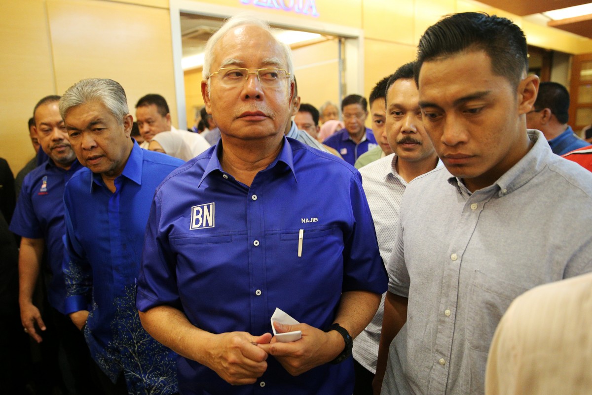 Malaysia's outgoing Prime Minister Najib Razak walks ...